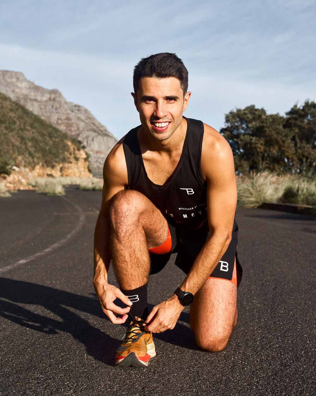 Nic Acampora, the Half Marathon Kickstart running coach, tying his shoelace and getting ready for a run, inspiring runners to prepare for their training.